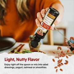 Barlean's flaxseed oil droplets on a spoon ready to mix into meals