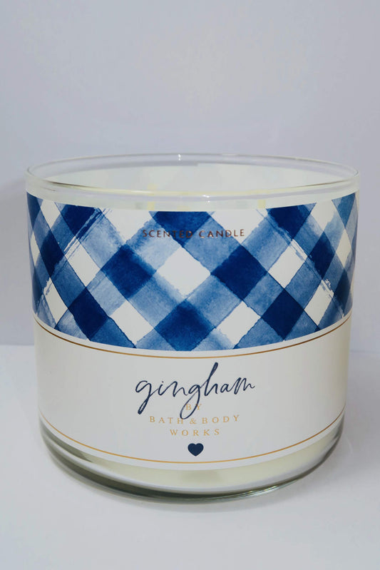 Bath and Body Works Gingham candle-lit jar glows softly, ideal for cozy evenings.
