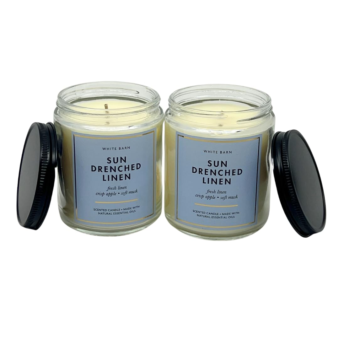 Bath and Body Works Sun Drenched Linen candle wick lighting creates warm ambiance.