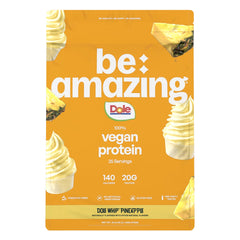 BE AMAZING vegan protein powder Dole Whip Pineapple bottle pour highlights creamy texture and pouring action