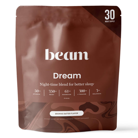 Beam Dream Sleep Powder brownie batter tub on countertop signals a calming routine.
