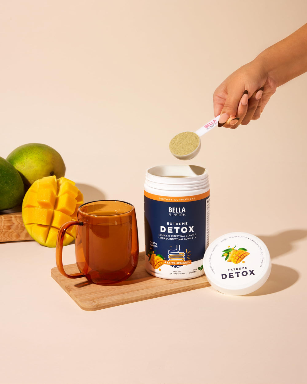 Bella All Natural Detox Powder Mango glass with drink highlighting gentle digestion