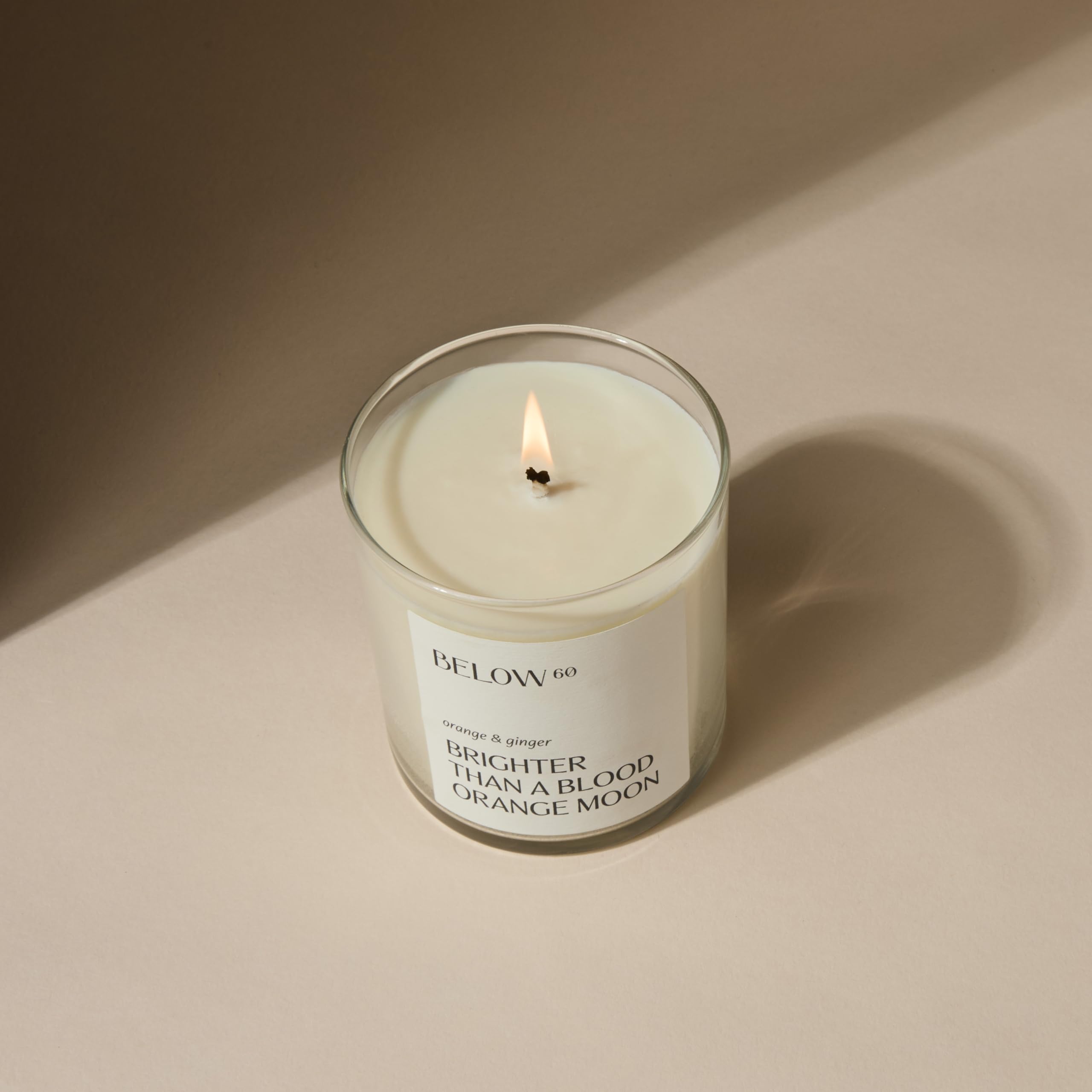 Below 60 blood orange ginger candle side view for daytime glow