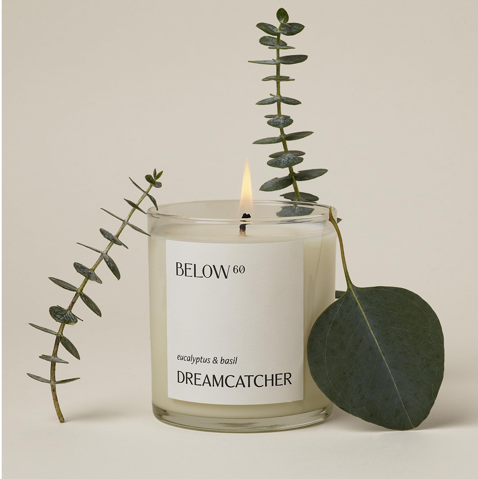 Below 60 Dreamcatcher candle close-up of label with warm glow for a clean, soothing burn.