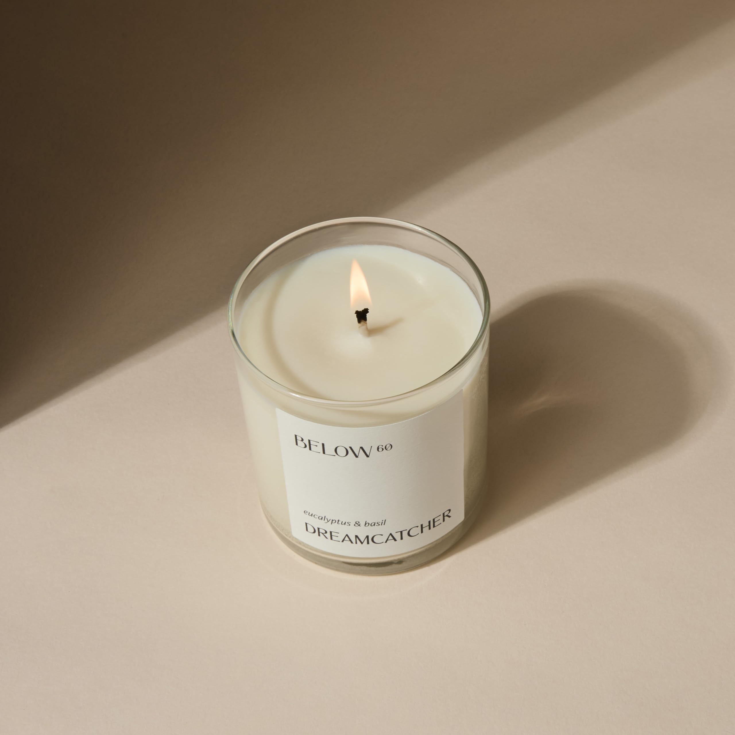 Below 60 Dreamcatcher candle packaging and lid shown, ideal gift-ready natural aroma.