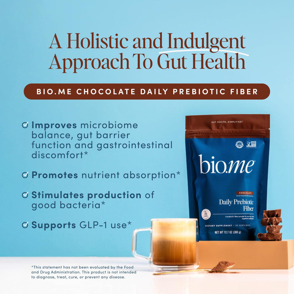 Bio.me powder scoop beside a glass ready to blend into beverages.