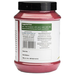 Scoop of Bixa Botanical Hibiscus Powder for internal use with juice.