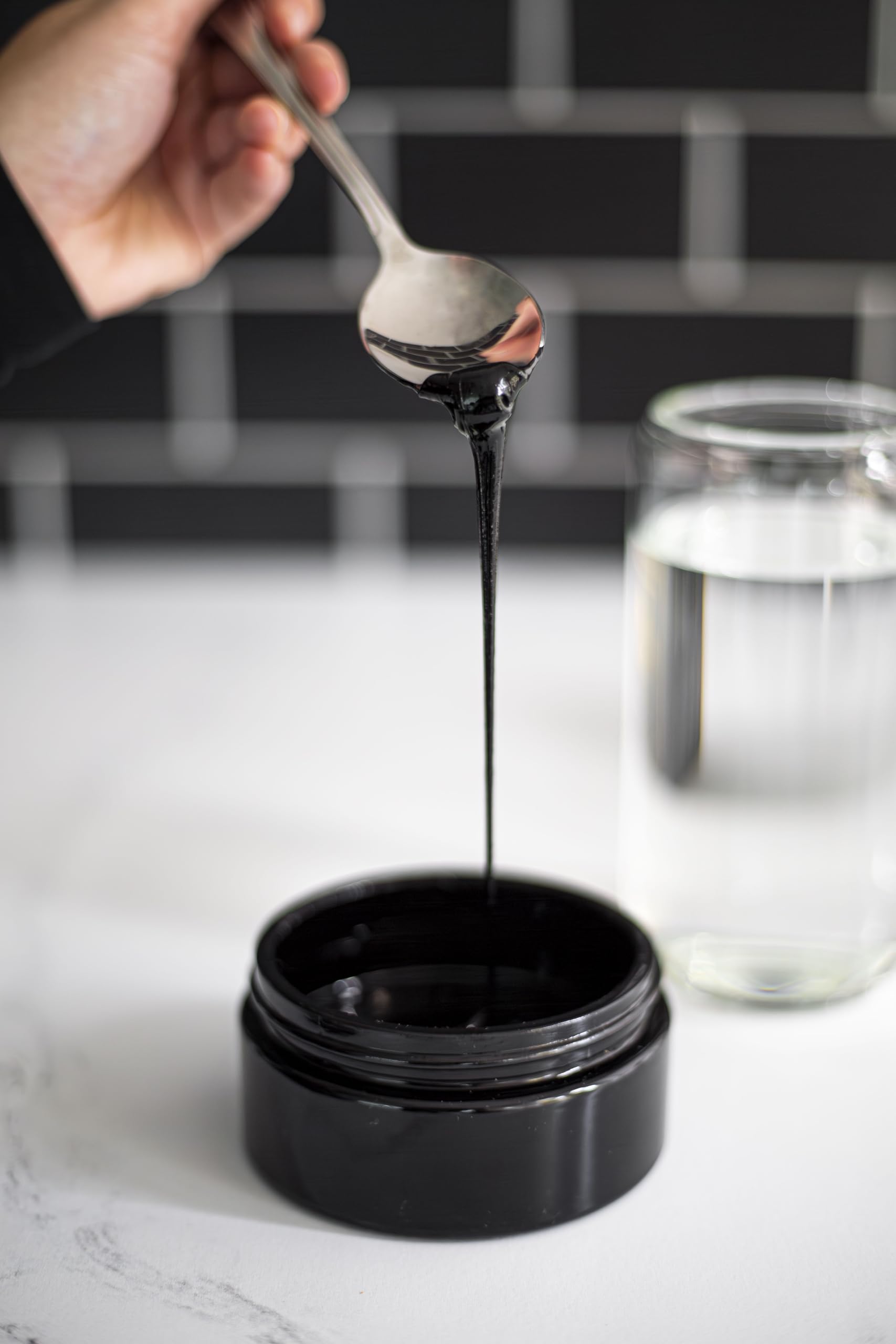 Black Lotus Shilajit resin dissolving in water for a simple daily ritual.