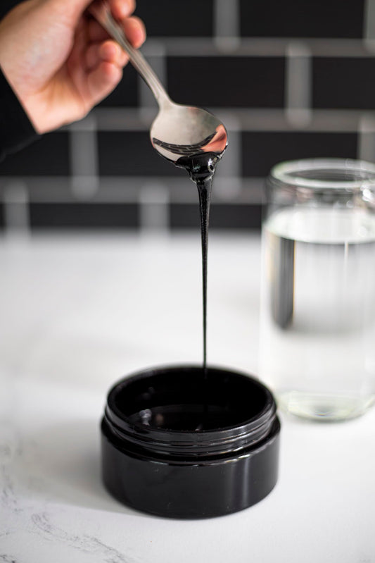Black Lotus Shilajit resin dissolving in water for a simple daily ritual.