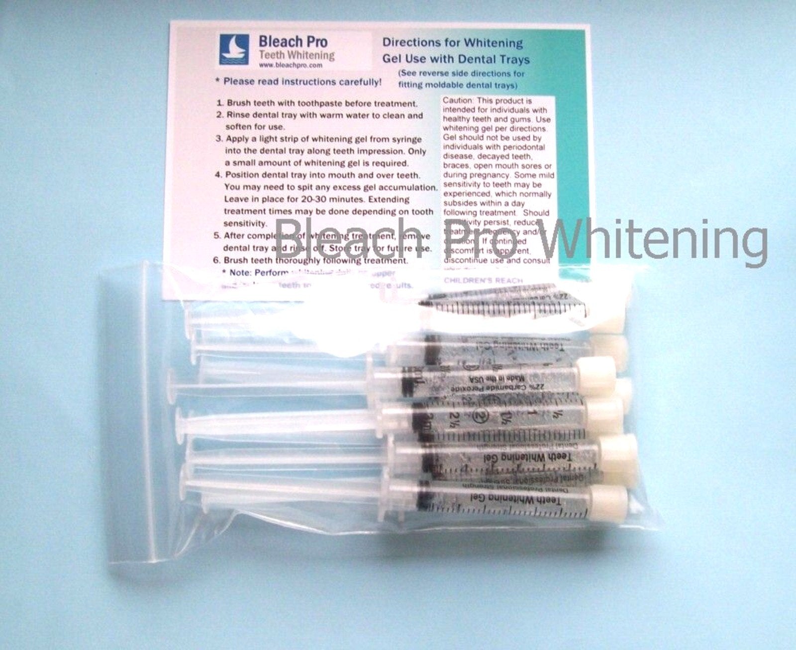Bleach Pro Whitening 3ml syringe applying gel along teeth for even coverage.