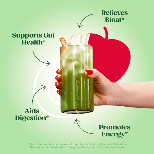 Bloom Nutrition greens powder scoop poured into a glass for a convenient energy boost.