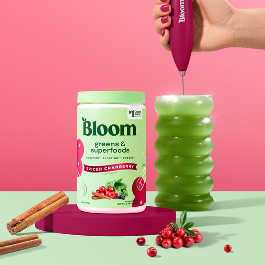 Closeup of Bloom greens powder label highlighting probiotics and prebiotics for gut health.