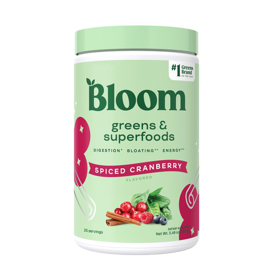 Bloom Nutrition greens powder tub with spiced cranberry flavor supports daily energy and digestion.
