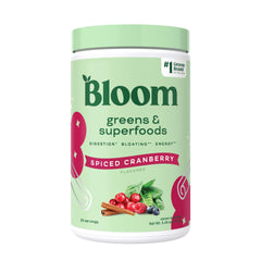Bloom Nutrition greens powder tub with spiced cranberry flavor supports daily energy and digestion.