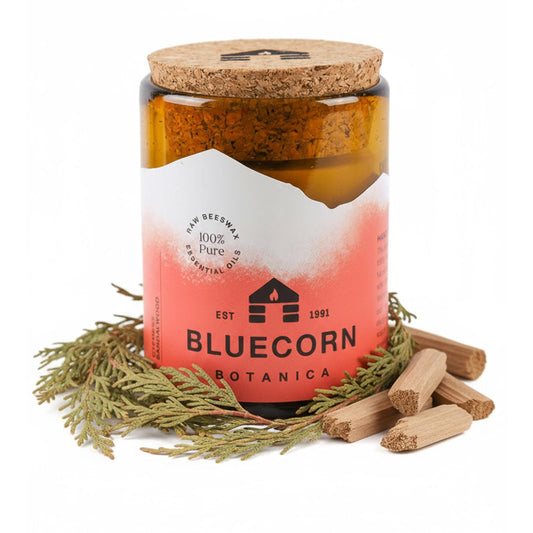 Bluecorn Beeswax Candle in amber glass holder casts a warm glow for cozy evenings.