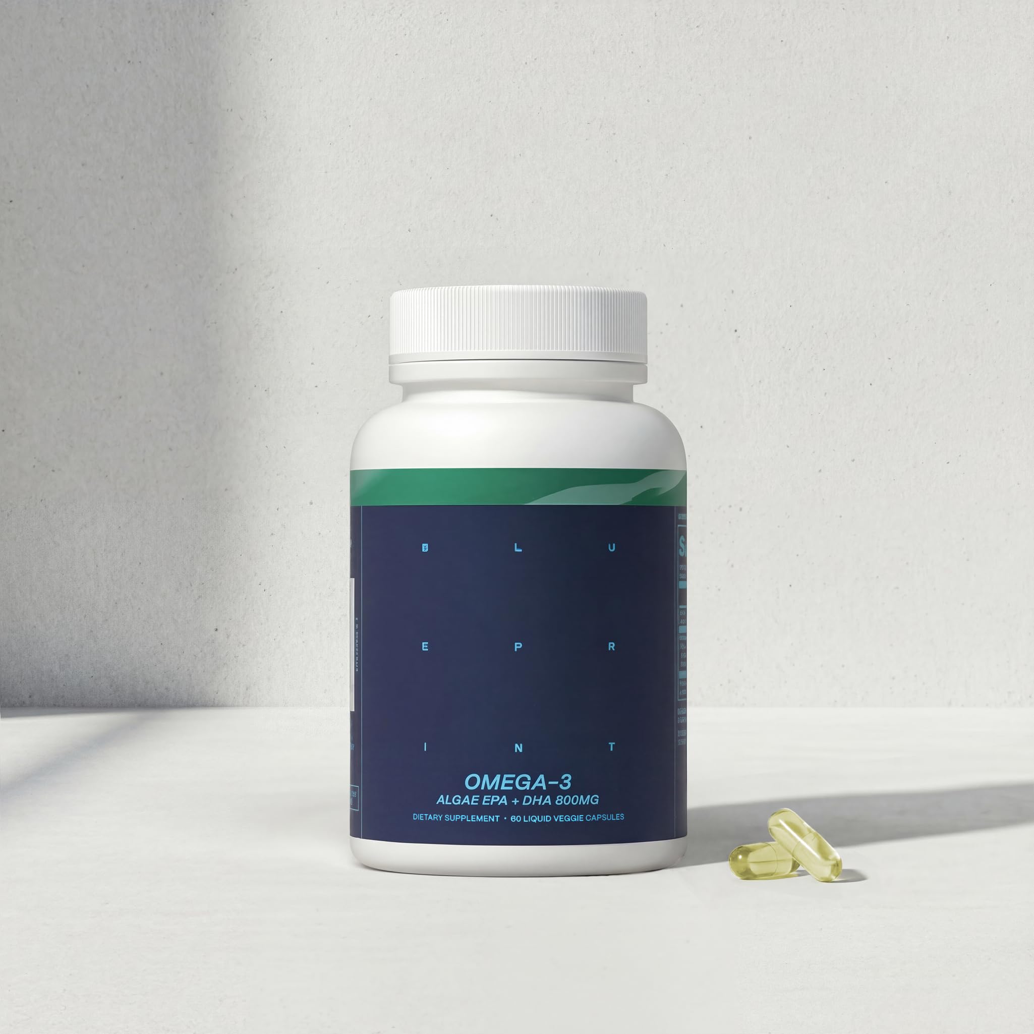 Blueprint Bryan Johnson Omega-3 bottle on desk ready for daily routine.