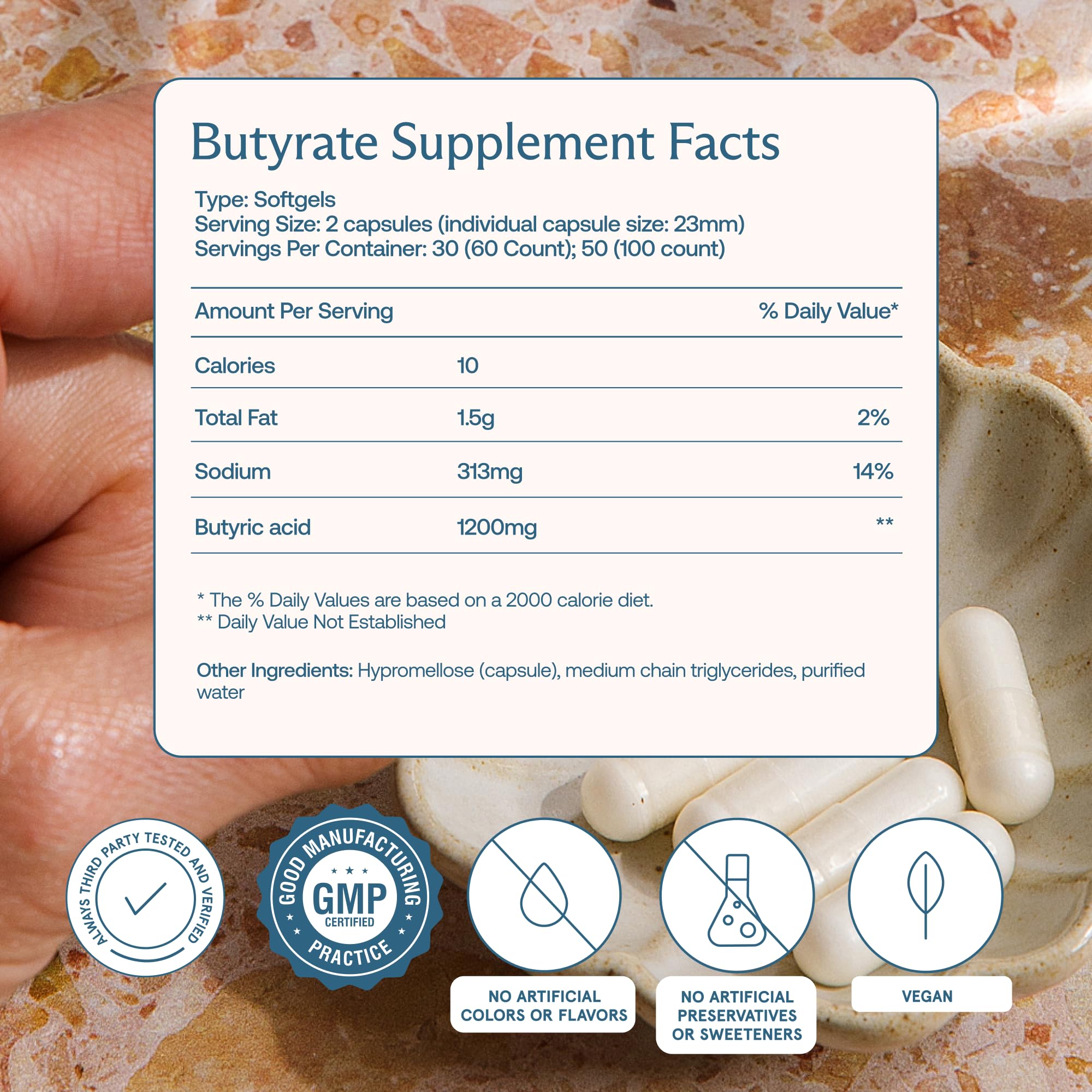 BodyBio Butyrate capsules in hand suggest daily gut support.