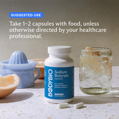 Hand holding BodyBio Butyrate bottle for convenient on-the-go support.