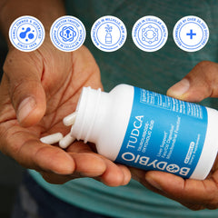 BodyBio TUDCA bottle beside glass of water in daily routine.