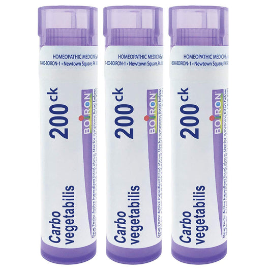 Boiron Carbo Vegetabilis pellets dissolving under tongue for quick, non-drowsy use.