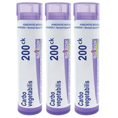 Boiron Carbo Vegetabilis pellets dissolving under tongue for quick, non-drowsy use.