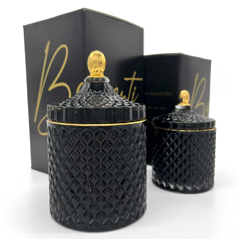 BRIGANTI soy candle in a black glass jar with gold rim highlighting mood-setting aroma.
