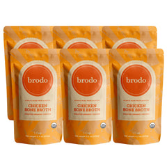 Brodo ready-to-drink organic chicken collagen bone broth bottle in a mug, 10 g protein per serving.