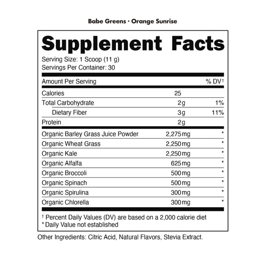 Bottle of Bucked Up Organic Greens Orange Sunrise beside fresh fruit for easy daily intake.