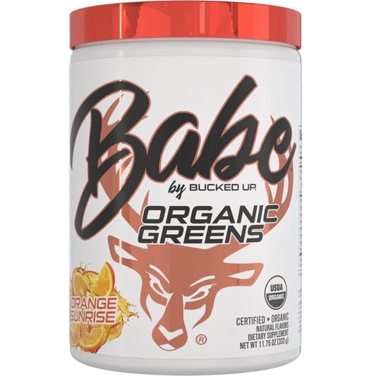 Bucked Up Greens Orange Sunrise powder scoop beside a glass smoothie for daily greens.