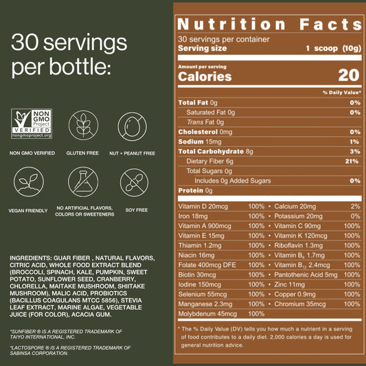 B.WILD bottle on table beside greens signaling natural ingredients for daily nourishment