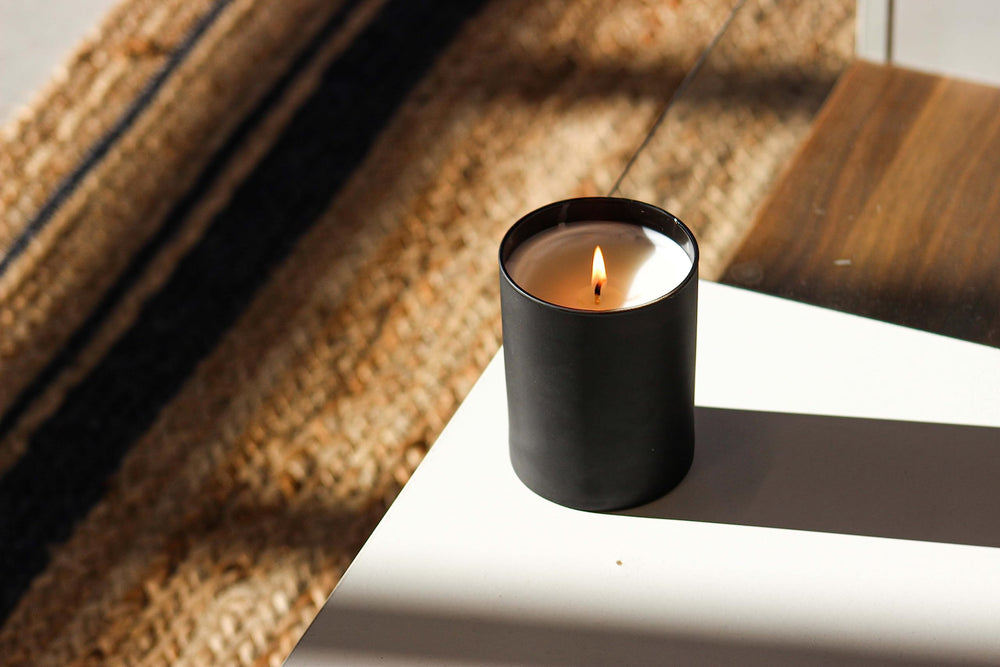 Calyan Wax Co. Lemon & Sage candle on nightstand for relaxing space