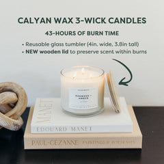 Calyan Wax Co. Oakmoss and Amber candle lit to create warm mood