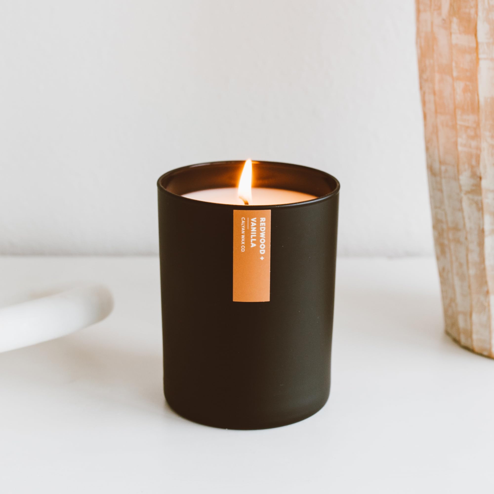 Calyan Wax Co. candle in a living room scene, luxurious ambiance