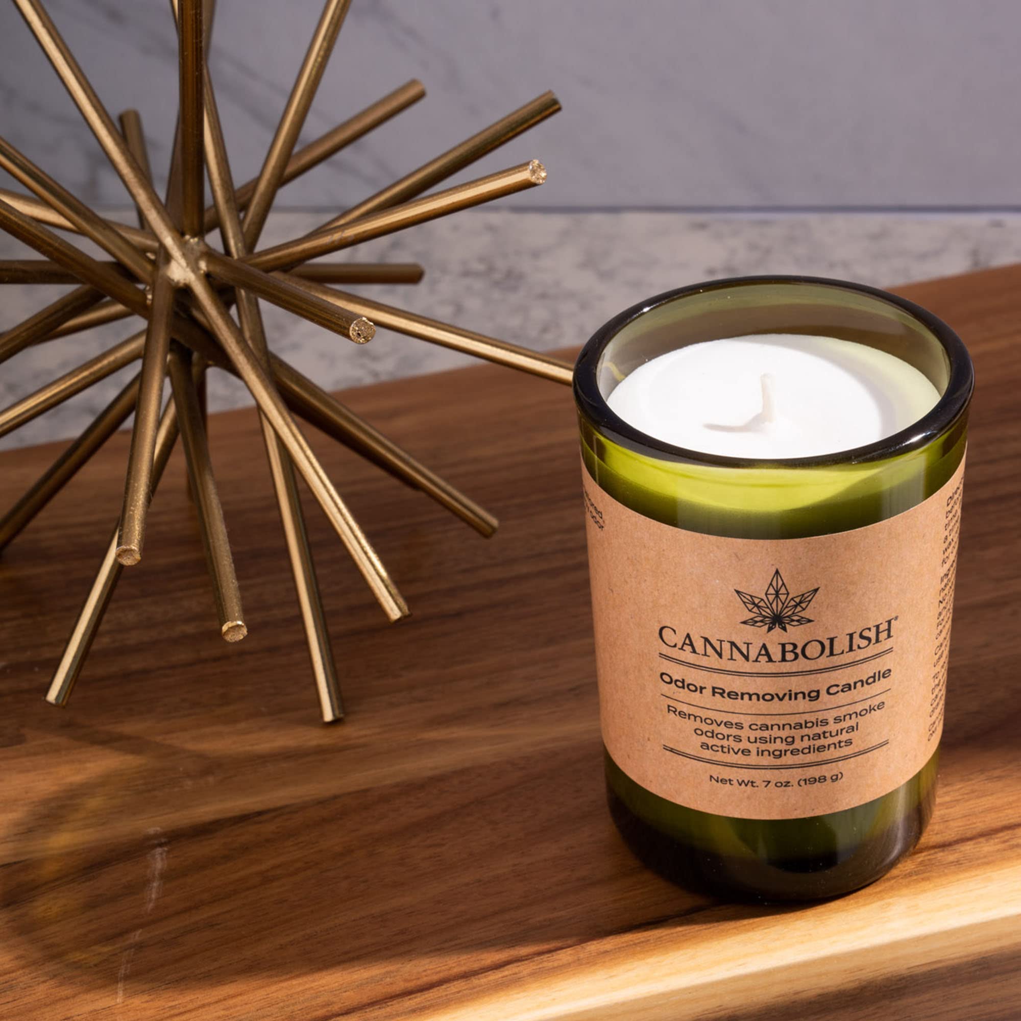 Cannabolish candle lit in a living room setup for room-wide scent management.