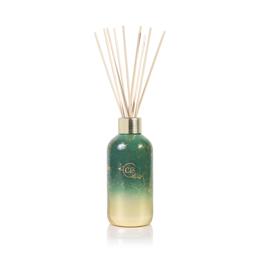 Capri Blue Glimmer Reed Diffuser Crystal Pine bottle provides flame-free scent for rooms.