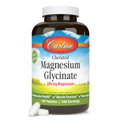 Carlson Chelated Magnesium 200 mg bottle beside a glass of water for easy daily supplementation.