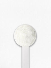 Carlyle Multi Collagen Powder with scoop beside glass of water.