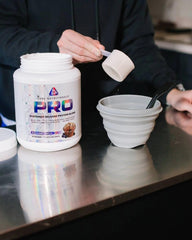 Scoop of Core PRO powder beside shaker for post-workout shake
