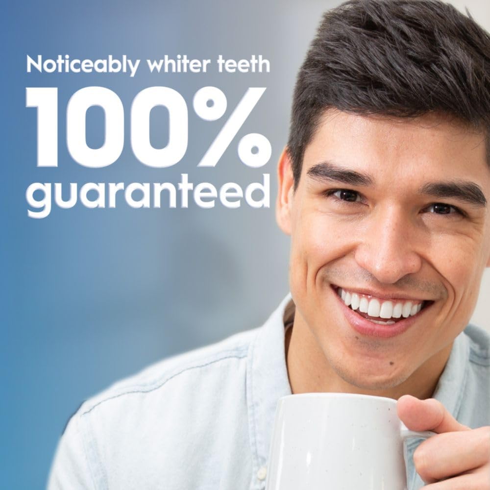 Crest 3D Whitestrips Sensitive + LED Light strip on lower teeth in use