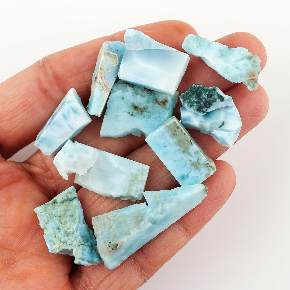 Crystalines Larimar raw slices on wire-wrapping setup, inspiring DIY crystal jewelry.