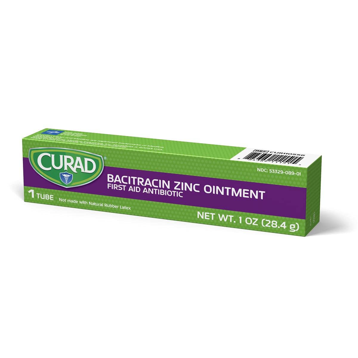 Hands applying Curad Bacitracin Zinc Ointment to a minor scrape.