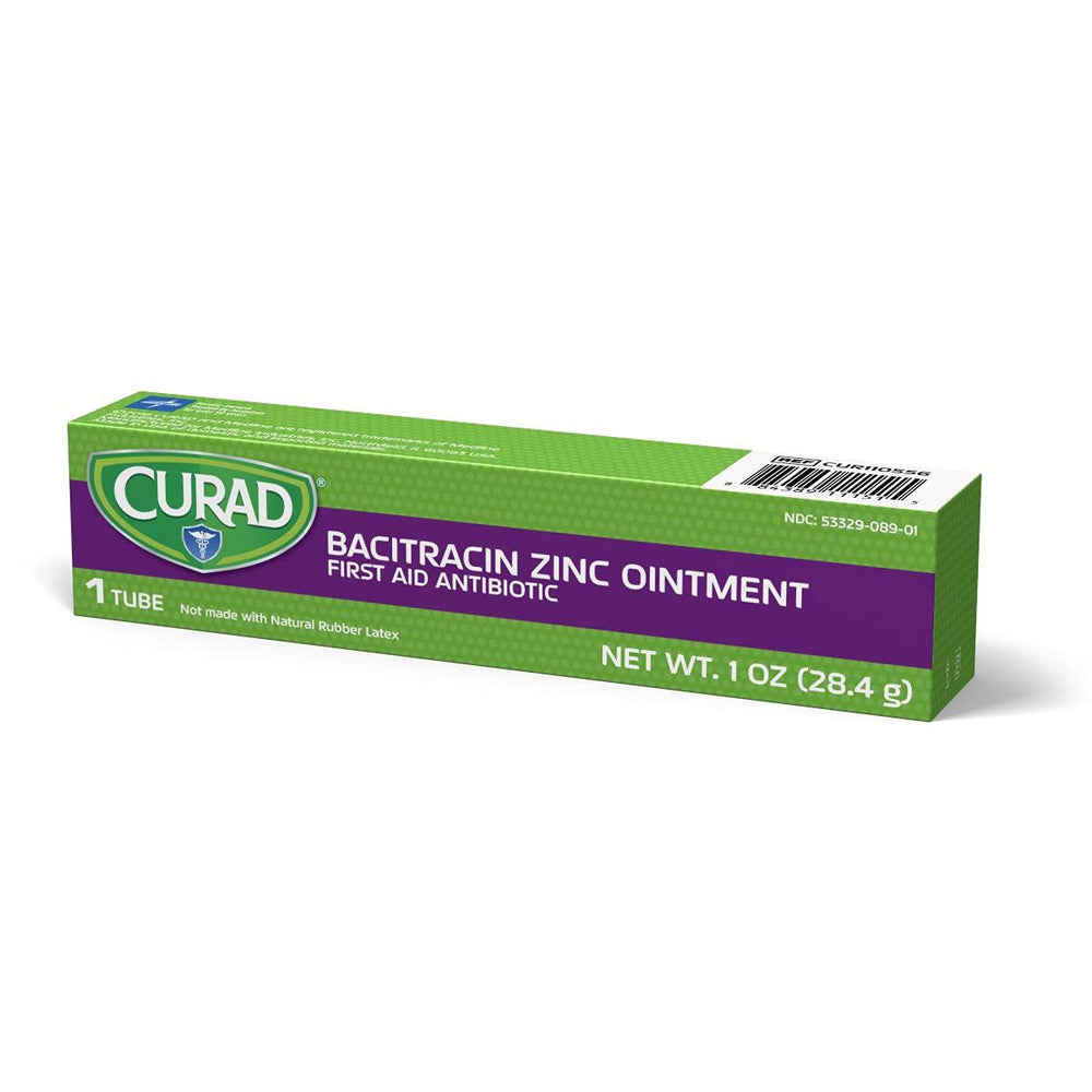Hands applying Curad Bacitracin Zinc Ointment to a minor scrape.