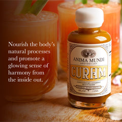 Anima Mundi Curam Elixir turmeric root and ingredients displayed for a wellness ritual.