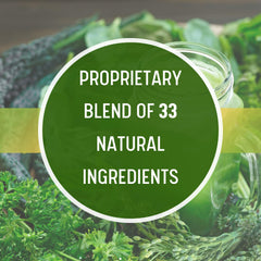 Glass with pale-green Daily Health Ultimate Greens drink prepared from powder.