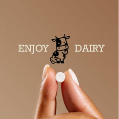 DairyPill bottle beside dairy foods, supports digestion during dairy occasions.