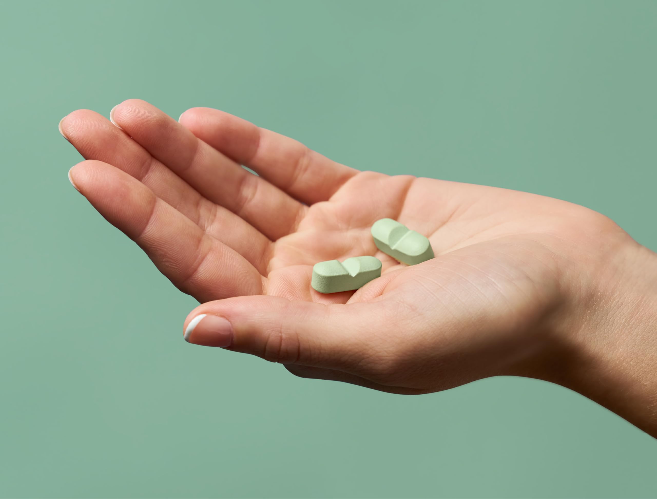 Divi Hair Growth Vitamins capsules close-up shows easy-to-take daily pills
