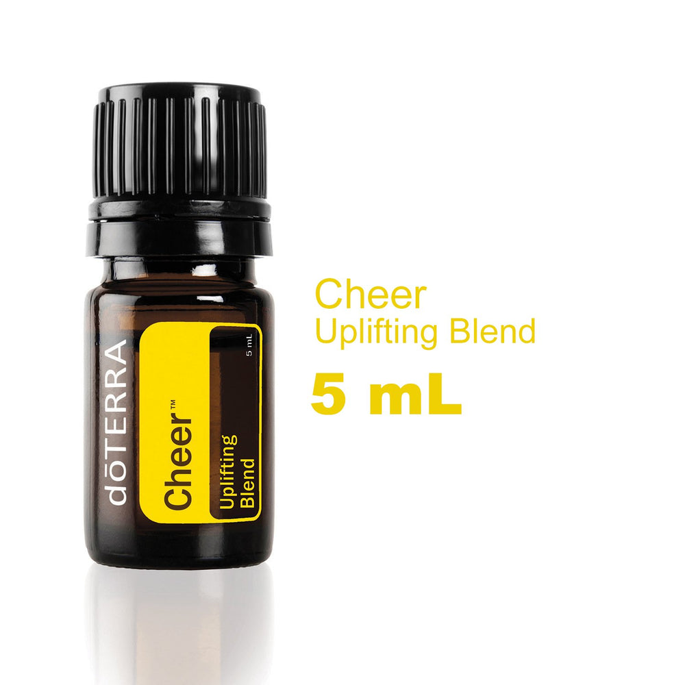 doTERRA Cheer bottle being poured to release a bright citrus-spice aroma.