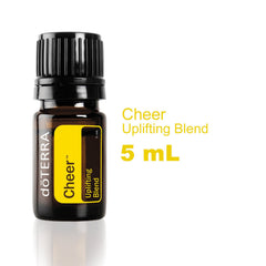 doTERRA Cheer bottle being poured to release a bright citrus-spice aroma.