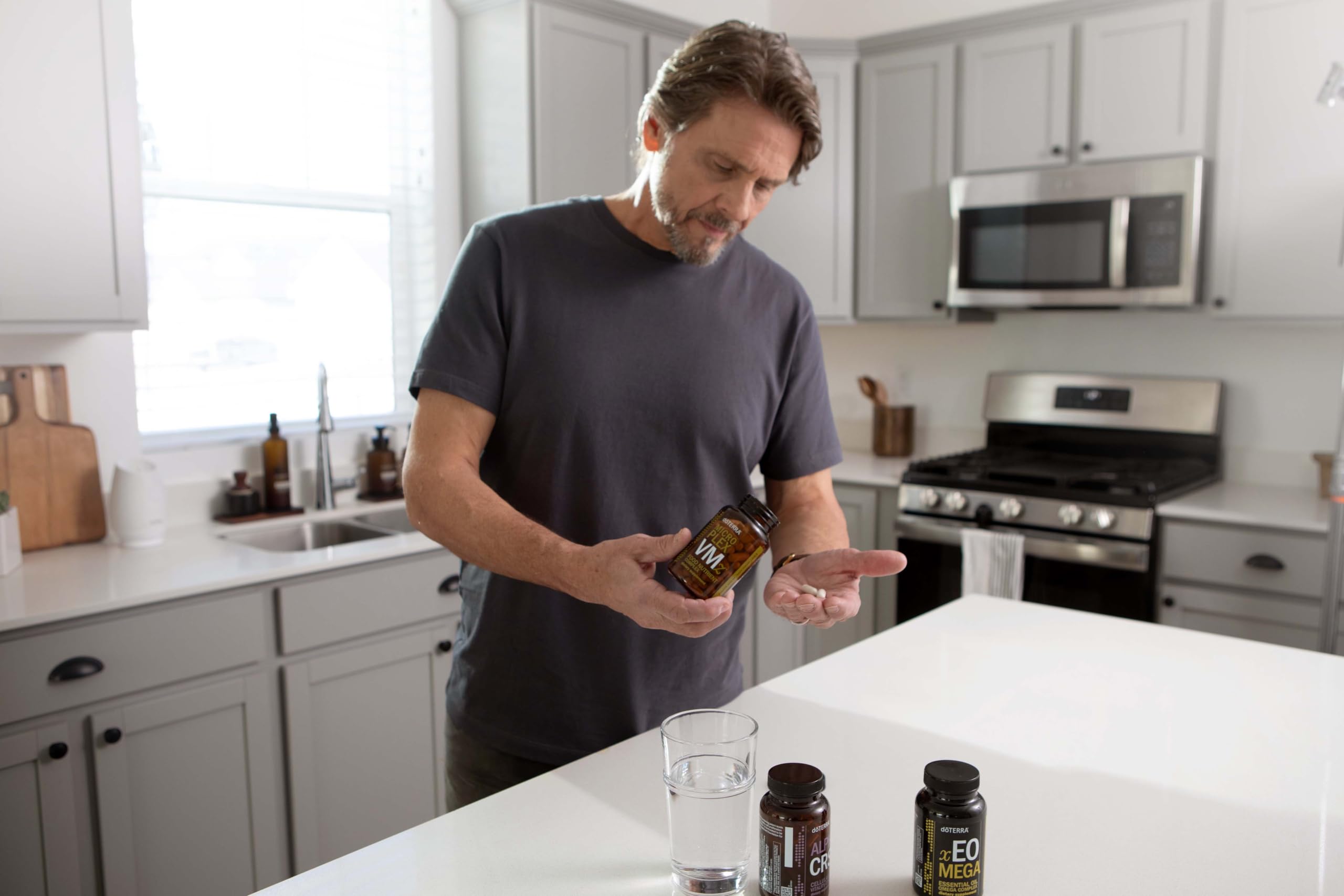 doTERRA MicroPlex VMz capsules in hand for convenient daily mineral intake