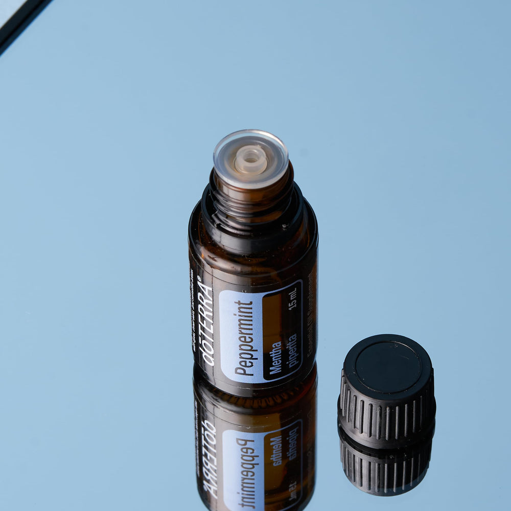 doTERRA Peppermint essential oil bottle pour demonstrates easy drop dispensing.